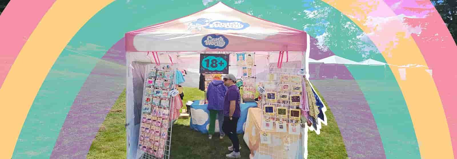 Crushworthy booth with rainbow graphic behind it